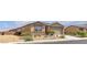 Single story home with tan stucco, a stone accent wall, and desert landscaping at 3964 E Marathon Dr, Pahrump, NV 89061
