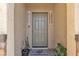 A welcoming front door with a welcome mat, potted plants, and decorative signs at 3964 E Marathon Dr, Pahrump, NV 89061