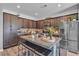 Stylish kitchen with granite countertops, stainless steel appliances, and a kitchen island with seating at 3964 E Marathon Dr, Pahrump, NV 89061