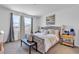 Bright and airy main bedroom with upholstered bed, bench, and large windows at 3964 E Marathon Dr, Pahrump, NV 89061