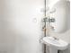 Chic powder room with pedestal sink, decorative mirror and stylish shelving at 4563 Townwall St, Las Vegas, NV 89115