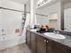 Full bathroom featuring granite countertops and a shower-tub combo at 4563 Townwall St, Las Vegas, NV 89115