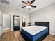 This is a bedroom with wood look floors and a large mirror at 4563 Townwall St, Las Vegas, NV 89115