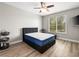 Bright bedroom features a ceiling fan, large window, and wood-look laminate flooring at 4563 Townwall St, Las Vegas, NV 89115
