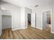 Spacious bedroom with wood flooring, neutral walls, and access to closet and ensuite bathroom at 4563 Townwall St, Las Vegas, NV 89115