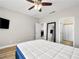 This is a bedroom with a TV, mirror and doorway to bathroom at 4563 Townwall St, Las Vegas, NV 89115