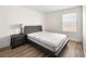 Bedroom features a window, side table and wood look floors at 4563 Townwall St, Las Vegas, NV 89115