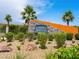 A welcoming entrance sign with lush greenery, palm trees, and decorative rock landscaping at 4563 Townwall St, Las Vegas, NV 89115