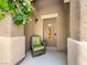 Inviting front door adorned with a seasonal wreath, complemented by a cozy chair for a warm welcome at 4563 Townwall St, Las Vegas, NV 89115