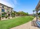 Scenic view of community green space with walking paths, manicured landscaping, and nearby homes at 4563 Townwall St, Las Vegas, NV 89115