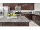 Beautiful kitchen island with stainless appliances and granite countertops at 4563 Townwall St, Las Vegas, NV 89115