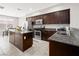 Well-equipped kitchen featuring an island, stainless steel appliances, and granite countertops at 4563 Townwall St, Las Vegas, NV 89115