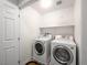 Functional laundry room equipped with modern washer and dryer, along with convenient overhead shelving at 4563 Townwall St, Las Vegas, NV 89115