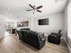 Open-concept living room with wood floors, ceiling fan, and modern furniture, perfect for relaxation and entertaining at 4563 Townwall St, Las Vegas, NV 89115