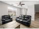 Inviting living room with comfortable leather furniture and abundant natural light at 4563 Townwall St, Las Vegas, NV 89115