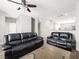 Spacious living room with neutral walls, wood floors and a contemporary ceiling fan at 4563 Townwall St, Las Vegas, NV 89115