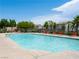 Community swimming pool perfect for relaxation, surrounded by palm trees and lounge chairs at 4563 Townwall St, Las Vegas, NV 89115
