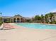 Community pool featuring lounge chairs, a clubhouse, and well-maintained landscaping at 4563 Townwall St, Las Vegas, NV 89115