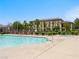 A community pool area includes palm trees, lounge chairs, hot tub, and surrounding buildings at 4563 Townwall St, Las Vegas, NV 89115
