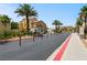 Well-kept street with palm trees and manicured landscaping within a vibrant community at 4563 Townwall St, Las Vegas, NV 89115