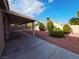 Expansive backyard featuring lush landscaping, a rock lawn, a covered patio, and a private block wall at 4704 Wild Oak Way, North Las Vegas, NV 89031