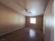 Bright bedroom featuring neutral walls, tiled floors, and a ceiling fan at 4704 Wild Oak Way, North Las Vegas, NV 89031