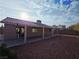 Backyard view showing a covered patio and desert landscaping at 4704 Wild Oak Way, North Las Vegas, NV 89031