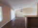 Spacious living room with tile flooring, neutral walls, and a modern chandelier at 4704 Wild Oak Way, North Las Vegas, NV 89031