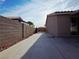 View of a concrete side yard, enclosed by a block wall with desert landscaping at 4704 Wild Oak Way, North Las Vegas, NV 89031