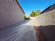 Concrete side yard enclosed by a block wall with rock landscaping and desert vegetation at 4704 Wild Oak Way, North Las Vegas, NV 89031