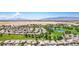 Extensive aerial view of a desert community with golf course, ponds, and mountain views at 5235 E La Campana Dr, Pahrump, NV 89061