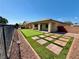 Beautiful backyard with pavers and green turf, enclosed by a fence for privacy at 5235 E La Campana Dr, Pahrump, NV 89061