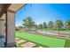 Backyard features a well-manicured lawn, artificial turf, and view of community green space at 5235 E La Campana Dr, Pahrump, NV 89061