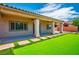 Large covered patio and low-maintenance artificial turf in backyard at 5235 E La Campana Dr, Pahrump, NV 89061