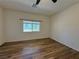 Bedroom with wood-look floors and a window overlooking the backyard at 5235 E La Campana Dr, Pahrump, NV 89061