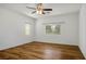 Bright bedroom with wood flooring, a ceiling fan, and natural light from two windows at 5235 E La Campana Dr, Pahrump, NV 89061
