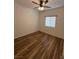 Cozy bedroom featuring wood-look floors, a ceiling fan, and a window at 5235 E La Campana Dr, Pahrump, NV 89061
