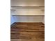 Walk-in closet with wood-look floors and built-in shelving at 5235 E La Campana Dr, Pahrump, NV 89061