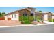 A single-story home with a stone facade, desert landscaping, and an attached garage at 5235 E La Campana Dr, Pahrump, NV 89061