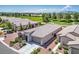 A single-story home with desert landscaping, a stone facade, and a two-car garage, situated in a golf course community at 5235 E La Campana Dr, Pahrump, NV 89061