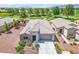Single-story home featuring desert landscaping, a stone facade, and an attached two-car garage, set on a golf course at 5235 E La Campana Dr, Pahrump, NV 89061