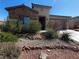 Inviting home with well-maintained desert landscaping, stone accents, and a neutral color palette at 5235 E La Campana Dr, Pahrump, NV 89061