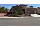 Charming single-story home with stone accents, desert landscaping, and a two-car garage at 5235 E La Campana Dr, Pahrump, NV 89061