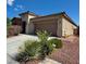 Welcoming single-story home with a two-car garage and attractive desert landscaping in the front yard at 5235 E La Campana Dr, Pahrump, NV 89061