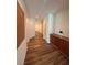 Well-lit hallway with wood-look flooring and neutral wall paint at 5235 E La Campana Dr, Pahrump, NV 89061