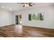 Bright living room with wood floors and sliding glass door to backyard at 5235 E La Campana Dr, Pahrump, NV 89061