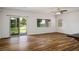 Bright living room with wood floors and sliding glass door to backyard at 5235 E La Campana Dr, Pahrump, NV 89061