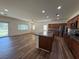 Open-concept living space with wood-look floors, recessed lighting, and a seamlessly integrated kitchen at 5235 E La Campana Dr, Pahrump, NV 89061
