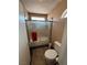Small bathroom featuring a glass shower, toilet, and a window for natural light at 5517 Rock Creek Ln, Las Vegas, NV 89130