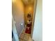 A view of a small bathroom with a toilet and dark red bathmat at 5517 Rock Creek Ln, Las Vegas, NV 89130